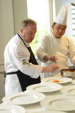 <br />Chef Joachim Koerper preparing the dishes for the guests