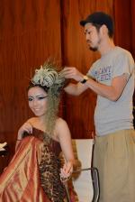 <br />Placing the headpiece on model's head before the fashion show